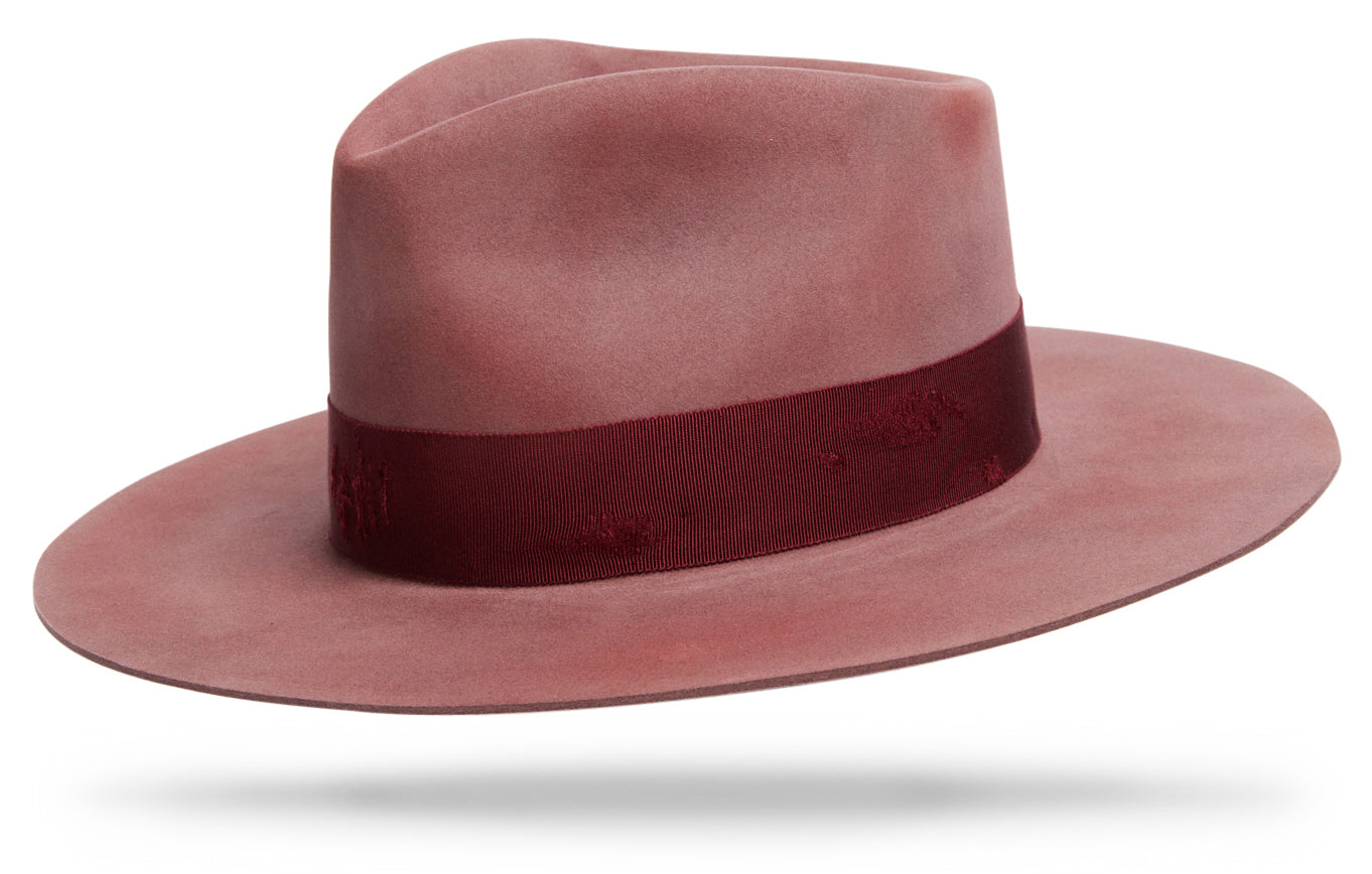 Design
Like the Arizona sandstones illuminated by the rising and setting sun, the Sedona invokes the beauty and the mystery of a desert flower. With its 4 1/2 teardrop crown and 3 1/2 straight brim this beautiful dusty rose weather refined will brighten any outfit. 
Material
100% Fur Felt Beaver blend Hat sustainably acquired.
Specifications
- Dusty rose fur felt  hat hand dyed and weather-refined- 4 1/2 teardrop crown- 3 1/2 straight brim - Adorned with a cotton distressed in bordeaux 1 1/2 band- Handcrafted in our NYC atelier.