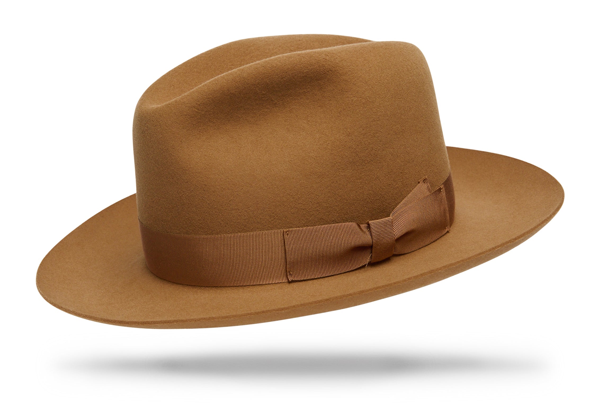 
Design
Our new spin on our timeless classic, the Sienna carries a 4 C-crown and holds a 3' snap brim. Should be a staple in your wardrobe.
Material
Fur felt, sustainably acquired.
Specifications
A 115-gram fur felt beauty. The Sienna holds a 3 snap brim with a classic 4 C-crown. A refined camel, harmonized with a tone-on-tone double bow hatband.Handcrafted in our NYC atelier.