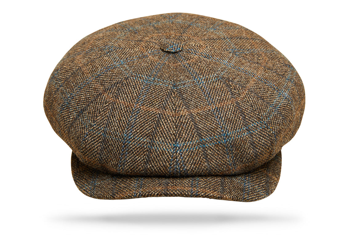 
Design
Commonly known as the Big Apple, the 8 paneled Gatsby invokes a boyish spirit with its matching button and sewn-down visor.Fully lined for comfort. Brown herringbone windowpane
Material
100% pure Wool.
Specifications
100% pure Wool.Handmade in Italy for Worth & Worth.
