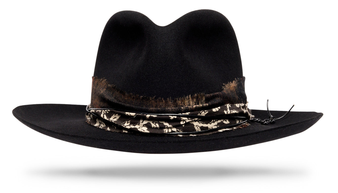 Design
A deep, inky black with quiet strength and unmistakable character. Crafted from our softest 100% beaver felt, weighing just 90 grams, it feels featherlight — almost fluid in hand. Designed to shape and collapse naturally, the Vagabond takes on its own form with time, reflecting the journey of its wearer. Finished with a block-printed cotton band, handmade and naturally dyed through an ancestral Indian textile tradition using hand-carved wooden blocks — a timeless detail that completes its understated ease.
Material
100% dressed beaver sustainably acquired
Specifications
- A dressed beaver fur felt of 90 grams is extremely soft and shapable to your desire.- 3 ¼  brim and 4 soft malleable crown.- Block printed cotton band  handmade and naturally dyed - Leather cord- Finished with our hand silk printed band. - Handcrafted in our NYC atelier.