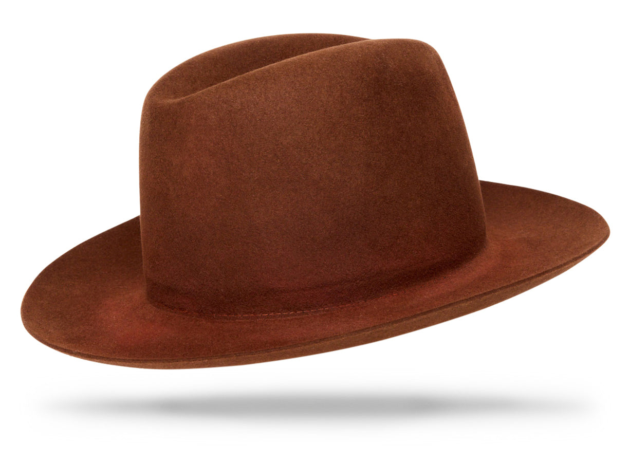 Design
From the Himalayas to the Sahara Desert, this hat has made the journey. We use an Ombre treatment, dying and redying the felt to drop complimentary overtones.
Material
100% Hare Fur Felt sustainably acquired and hand dyed
Specifications
- 2 3/4” brim with 4 crown, soft and malleable.- Graduated shades and tones of red iron oxide add a touch of dimension to the hat.- All our hats are exquisitely handmade, therefore they are unique and not identical. Even though we have the most attentive artisans who are the “Masters” of their craft, there may be natural variances in our products, especially custom dyed hats.