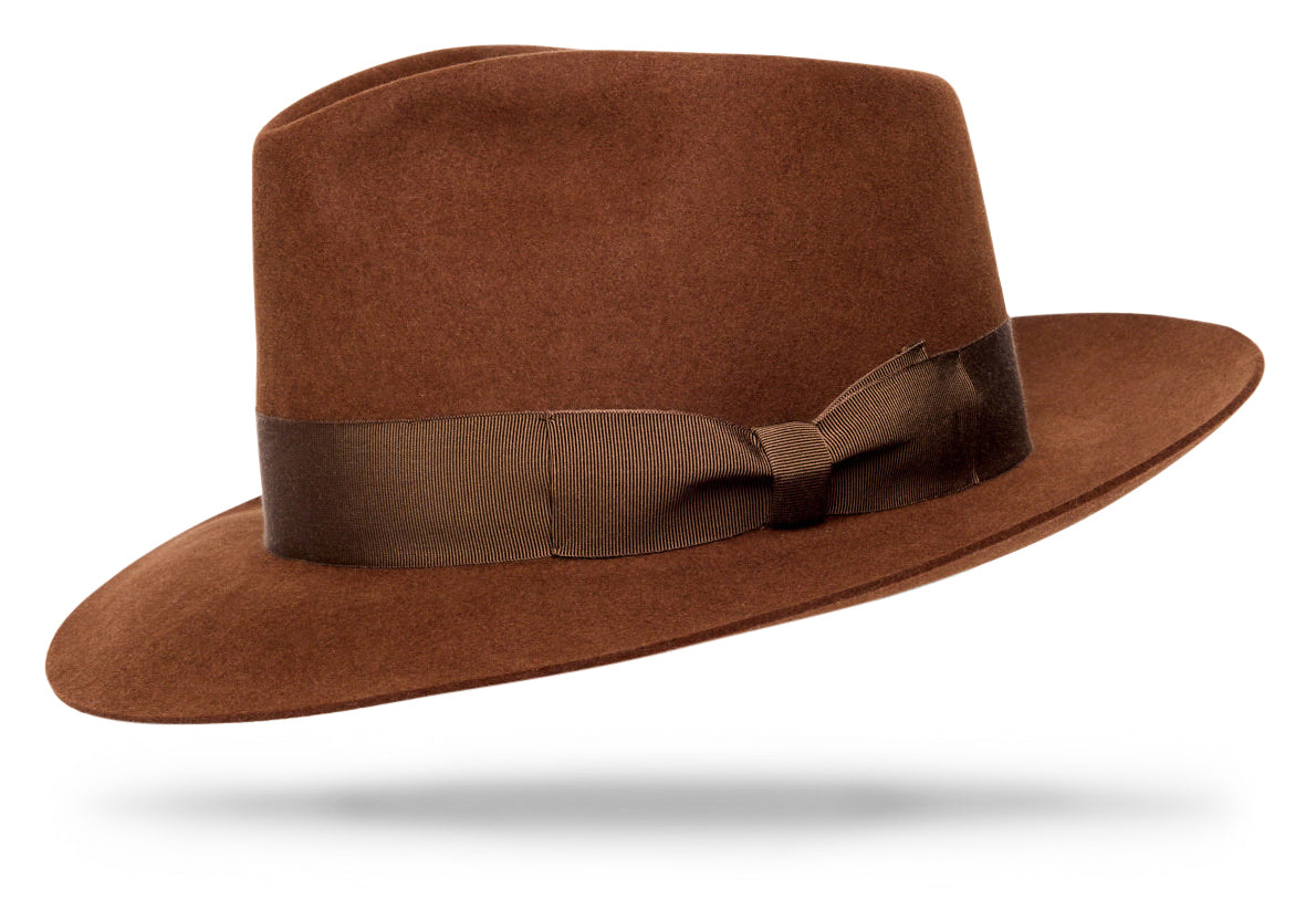 Design
A distinctive dress hat reminiscent of the times where the hat was a necessity for men and women. It boasts a 4” crown and a 2 ½” brim complete with a smart mushroom 1 ¼” hatband.***The model is wearing the Venezia Camel
Material
100% hare fur felt, sustainably acquired
Specifications
- 100% hare fur felt. - 4” crown and a 2 ½” brim complete with a smart 1 ¼” hatband. - Handcrafted in our NYC atelier.