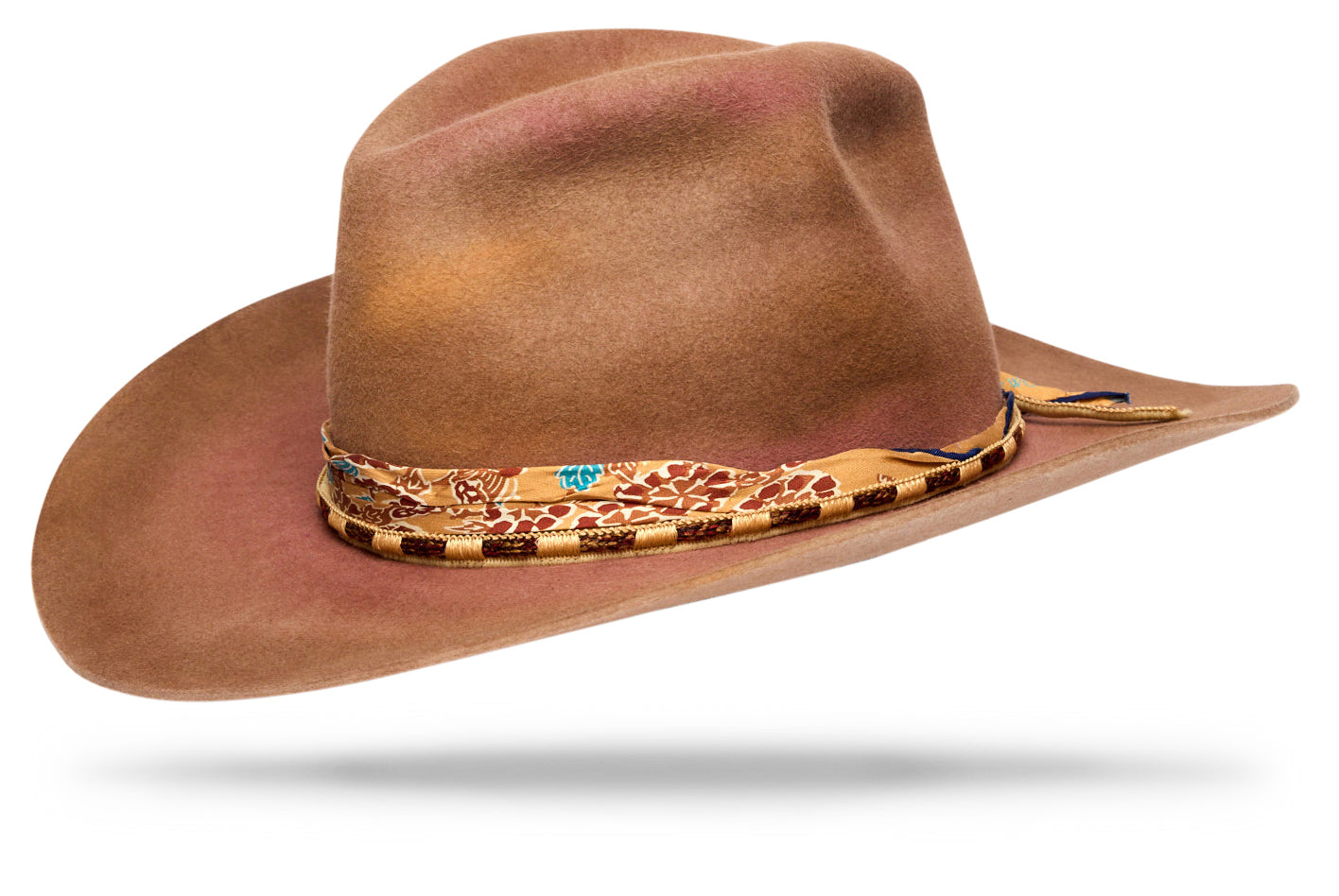 Design
Drawn from the Sundance ceremony — an act of devotion and renewal — this piece reflects the shifting dialogue between earth and sky. Shades of yellow, dusty rose, warm grey, and brown move together like the horizon in motion, where daylight burns into dusk. Handcrafted with a 4¼” diamante crown and 3½” brim, the Sundance holds a balanced presence — sculptural yet fluid. It’s finished with a handwoven cotton-and-silk cord and a W&W hand-printed silk band, details that carry the rhythm of the maker’s hand. A hat shaped by light — and the quiet strength it leaves behind.
Material
100% Western Beaver hand dyed Fur Felt Hat sustainably acquired. Natural dyeing minimizes the harmful effects on the surrounding environment. Our custom hats are hand dyed by using plants and vegetables base pigments.
Specifications
- Handcrafted with a 4¼” diamante crown and 3½” brim western shape - Finished with a handwoven cotton-and-silk cord and W&W hand-printed silk band- Handcrafted in our atelier in NYC. - Please allow 5-6 weeks to custom make this special piece.