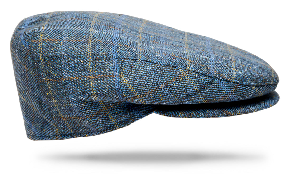 Design
Our most popular classic cap, inspired by the traditional British flat cap and reimagined in an exceptional blend of merino wool, silk and cashmere. Selected by Worth & Worth for its softness, warmth and subtle texture, the fabric is woven in County Donegal, Ireland, drawing on generations of textile expertise.
The cloth is then brought to Italy, where each cap is handmade by skilled artisans. Fully lined for comfort and designed to fold easily into your pocket, the Ivy Cap combines timeless character with refined craftsmanship and effortless versatility.
Material
75% Merino Wool 15% Silk 10% Cashmere  
Specifications
- 55% Silk- 45% Cotton- Blue Windowpane- Fully lined.- Woven in Ireland - Handmade in Italy for Worth & Worth.