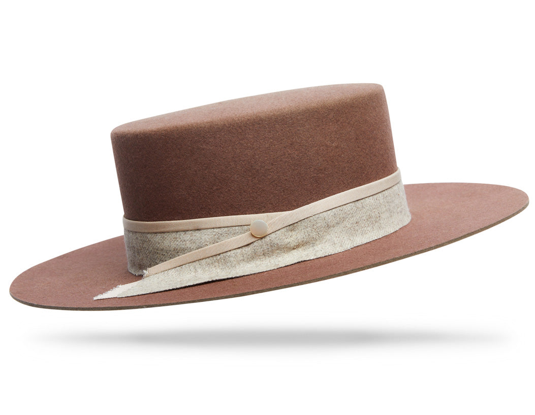 Design
The soft dusty rose color has warm gray undertones over the soft pastel, like the frescoes I had seen during my travels in Italy. Your winter essential.
Material
100% Dressed Beaver sustainably acquired and hand-dyed
Specifications
It wears a 4” flat top crown with a 3 1/2” tabletop brim. Hand-dyed and adorned around the crown with French wool, a subtle but distinctive mother-of-pearl button dots the band and draws the eye. Handmade in our atelier in NYC.Please allow 6-8 weeks to custom make this special piece.