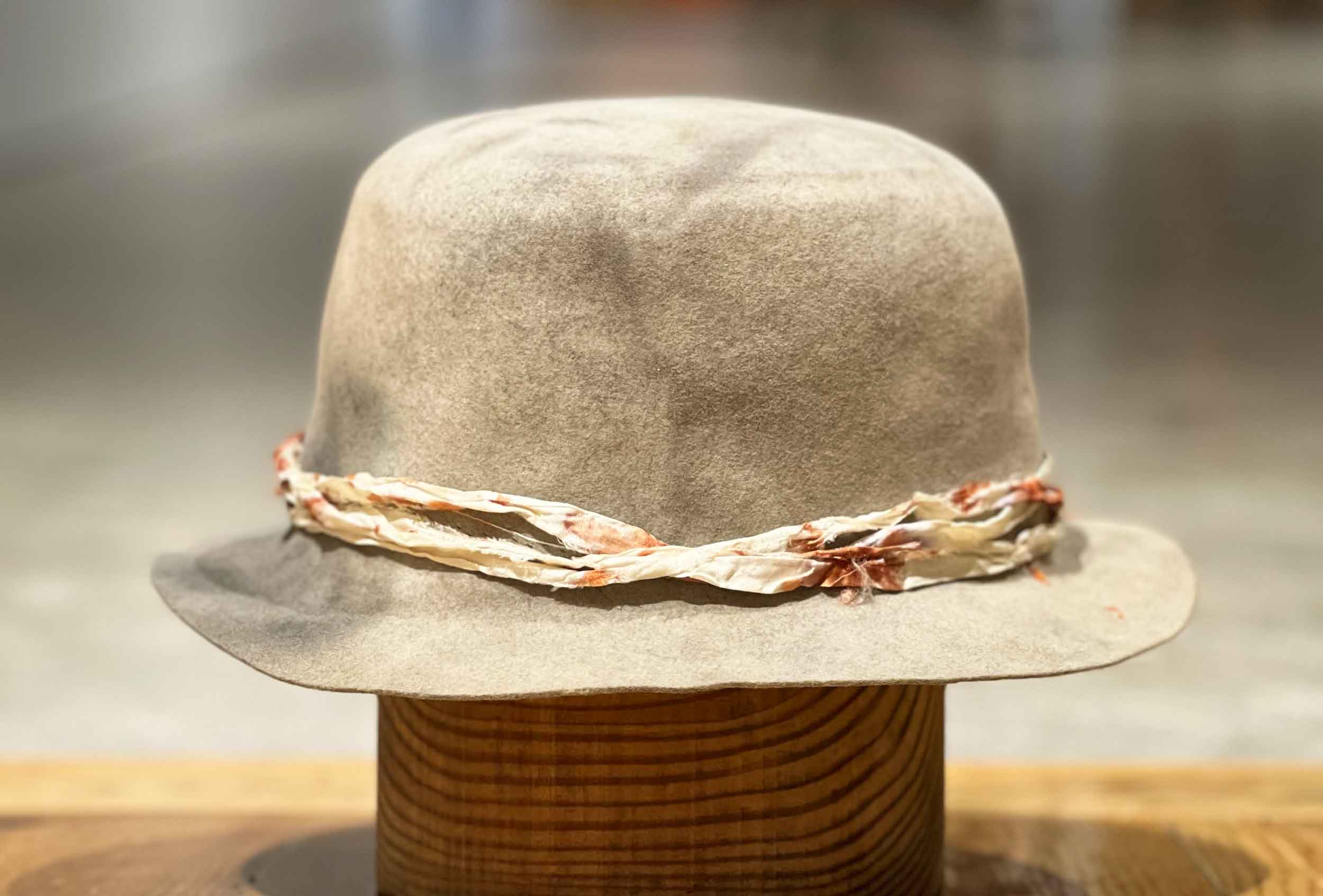 Design
A hat, subtle enough that just by touching it, the felt molds into any shape you desire. One unique piece is available for this bucket Hat. It can be size 7 1/8 or 7 1/4  please notify your preference when placing your order in the comments. 
Material
100% Hare Fur Felt sustainably acquired, weather refined, and hand dyed. Our custom hats are hand dyed by using plant and vegetable base pigments.
Specifications
- A 1 3/8 x brim with a 3 1/2 tapered round crown.- This one-of-a-kind piece is weather refined and has been edged and in a special dye treatment for over a year.- Ready to ship- Handmade in our atelier in NYC.