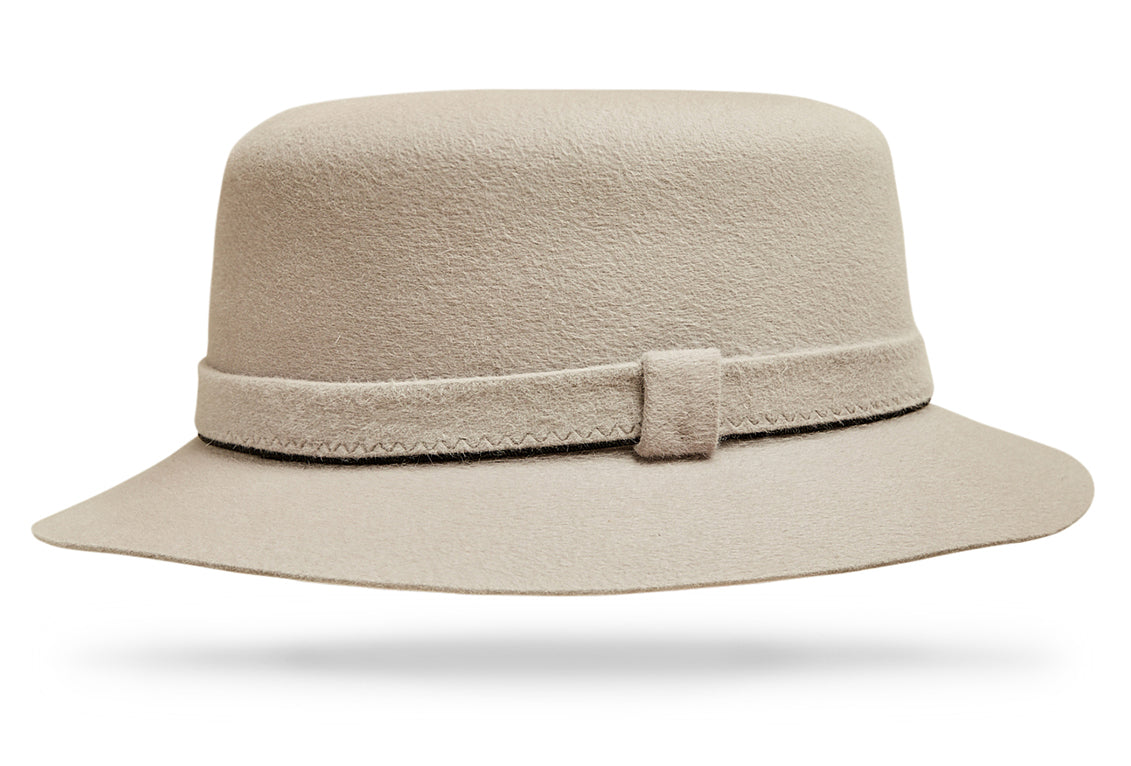 Design
Like a chip off an iceberg in Greenland... A white Italian cashmere hat with pink overtones and cool blue undertones. Made of 100% lustrous cashmere sits with a 3 1/4” semi-flat crown and a 2” brim, this bucket hat fully embodies casual chic.Not only comfy and easy but it’s elegant and worldly, the perfect accessory to cruise Madison or Flatbush Ave in mid-winter.
Material
100% Italian cashmere, color bone.
Specifications
The felt-on-felt hatband with its contrast complimentary edging takes detail oriented to the next level while the 2 brim and moderate crown effortlessly exude quality. Handmade in our atelier in NYC. 
